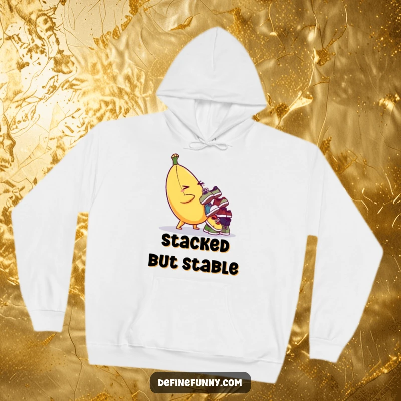 Funny hoodie featuring a mischievous banana character balancing a pile of mismatched shoes, perfect for cozy, humorous wear.
