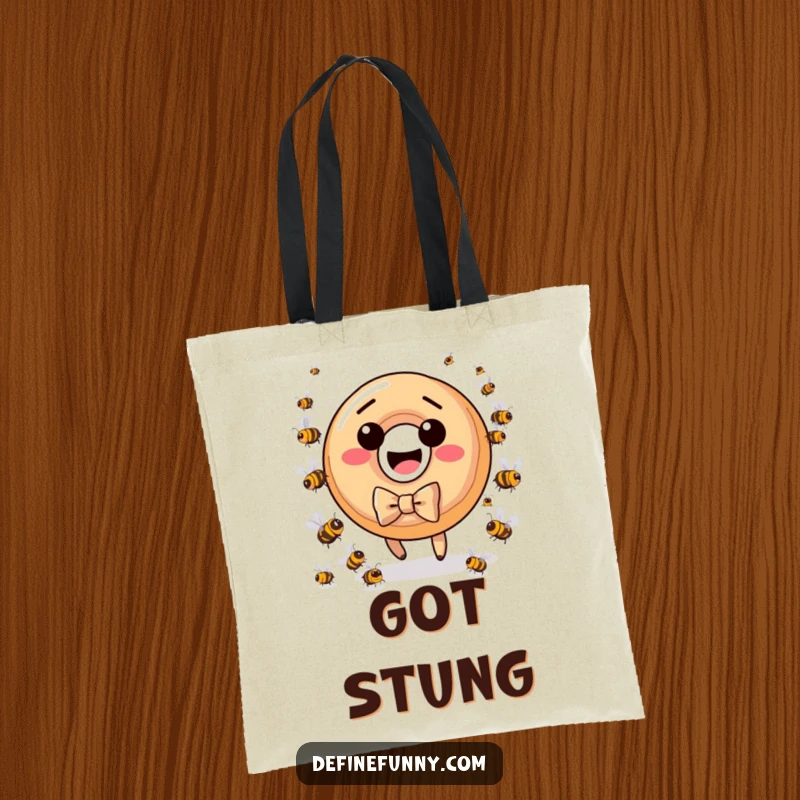 Funny donut character with bow tie, pursued by tiny bees, depicted on a durable tote bag.