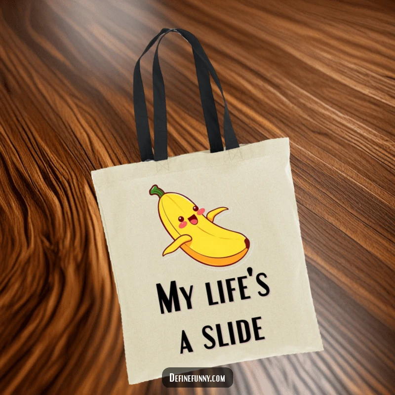 Funny Kawaii banana character with an ecstatic expression, sliding down its peel, featured on a practical and humorous tote bag.